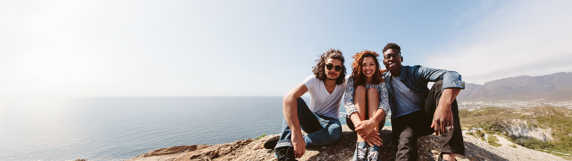 three people on the top of the mountain